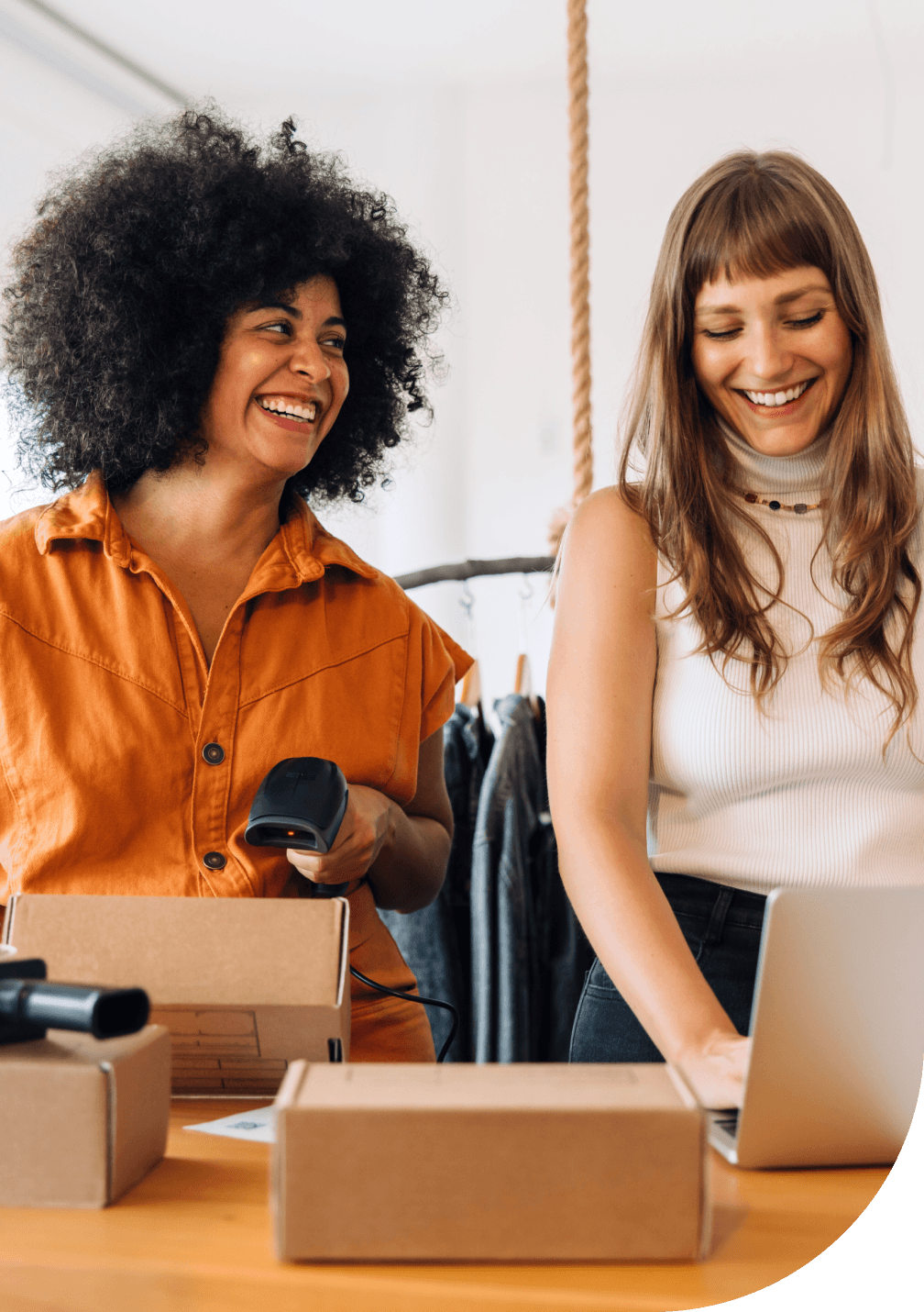 Two women smiling and collaborating at work.
