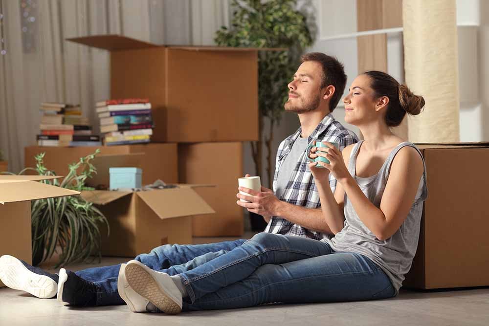 Happy couple moving home resting breathing fresh air