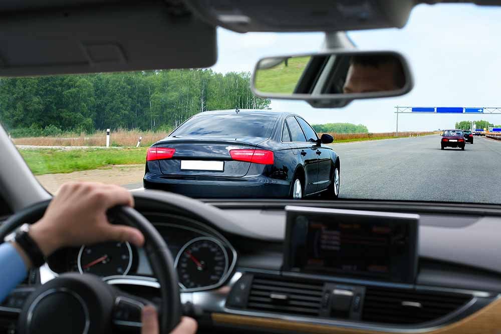 Man driving a car on a highway
