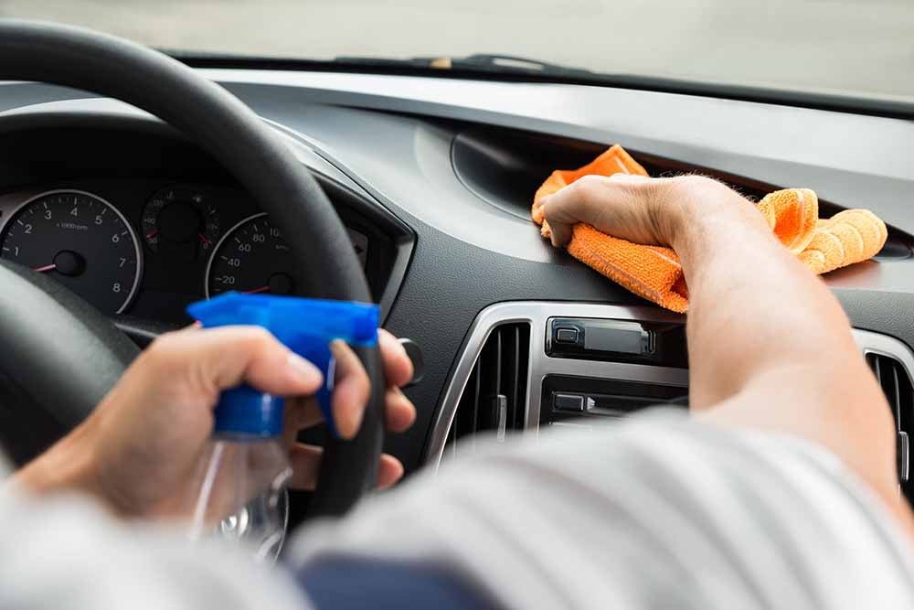 Man cleaning the interior of a car