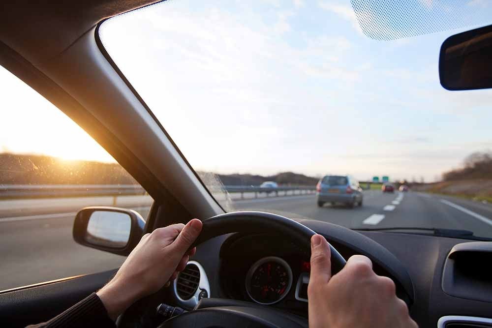Person driving a car on a highway