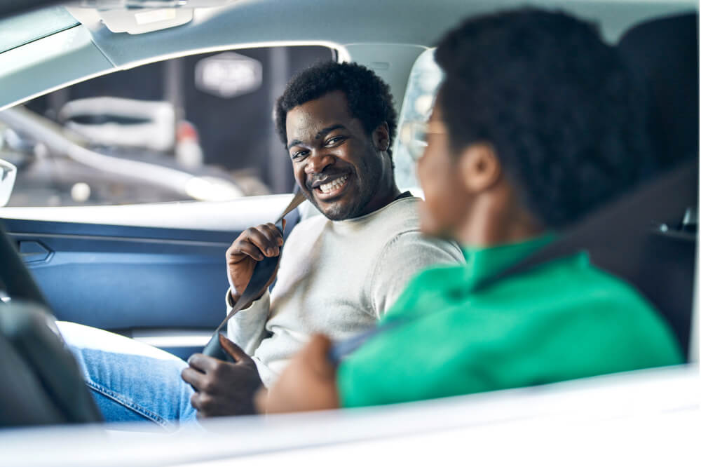 African american man and woman couple driving car at street