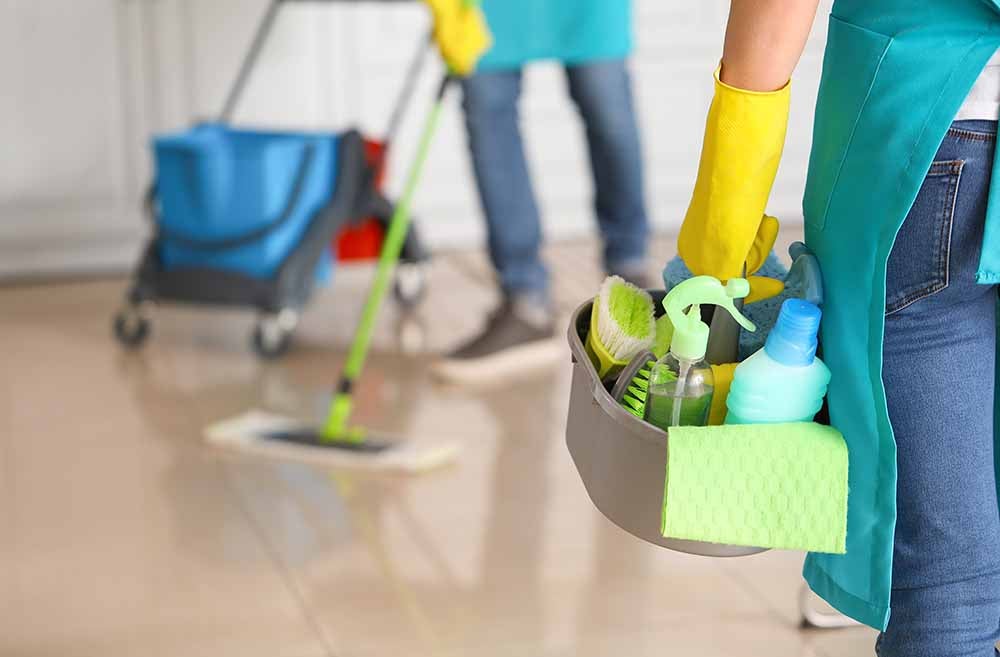 A man and a woman cleaning a home