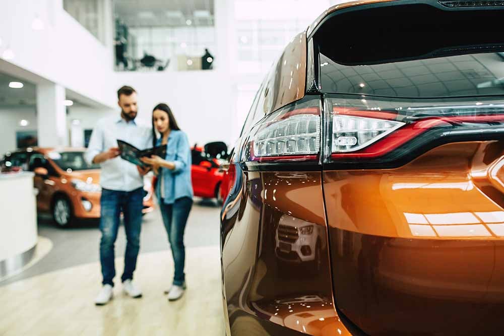 Young couple shopping for a new car