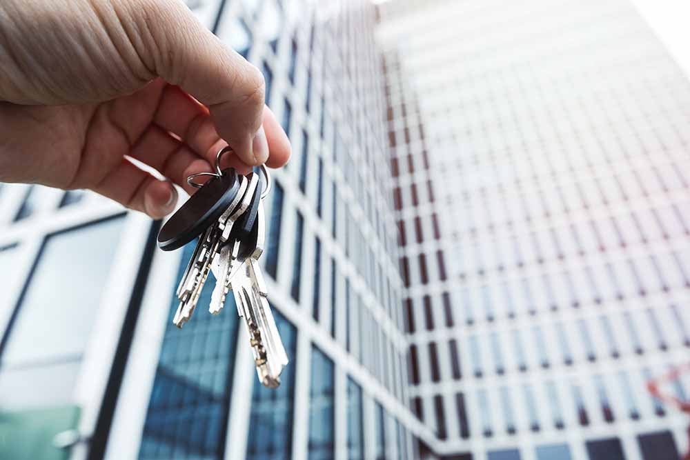 Une personne qui vient d'acheter un condo tient un jeu de clés
