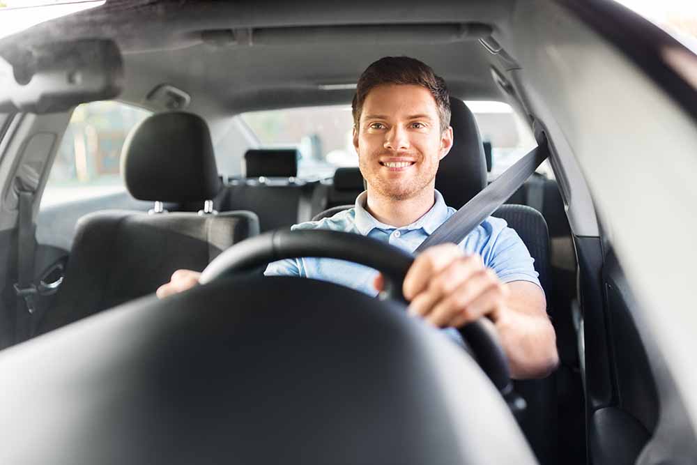 Man behind the wheel of a car