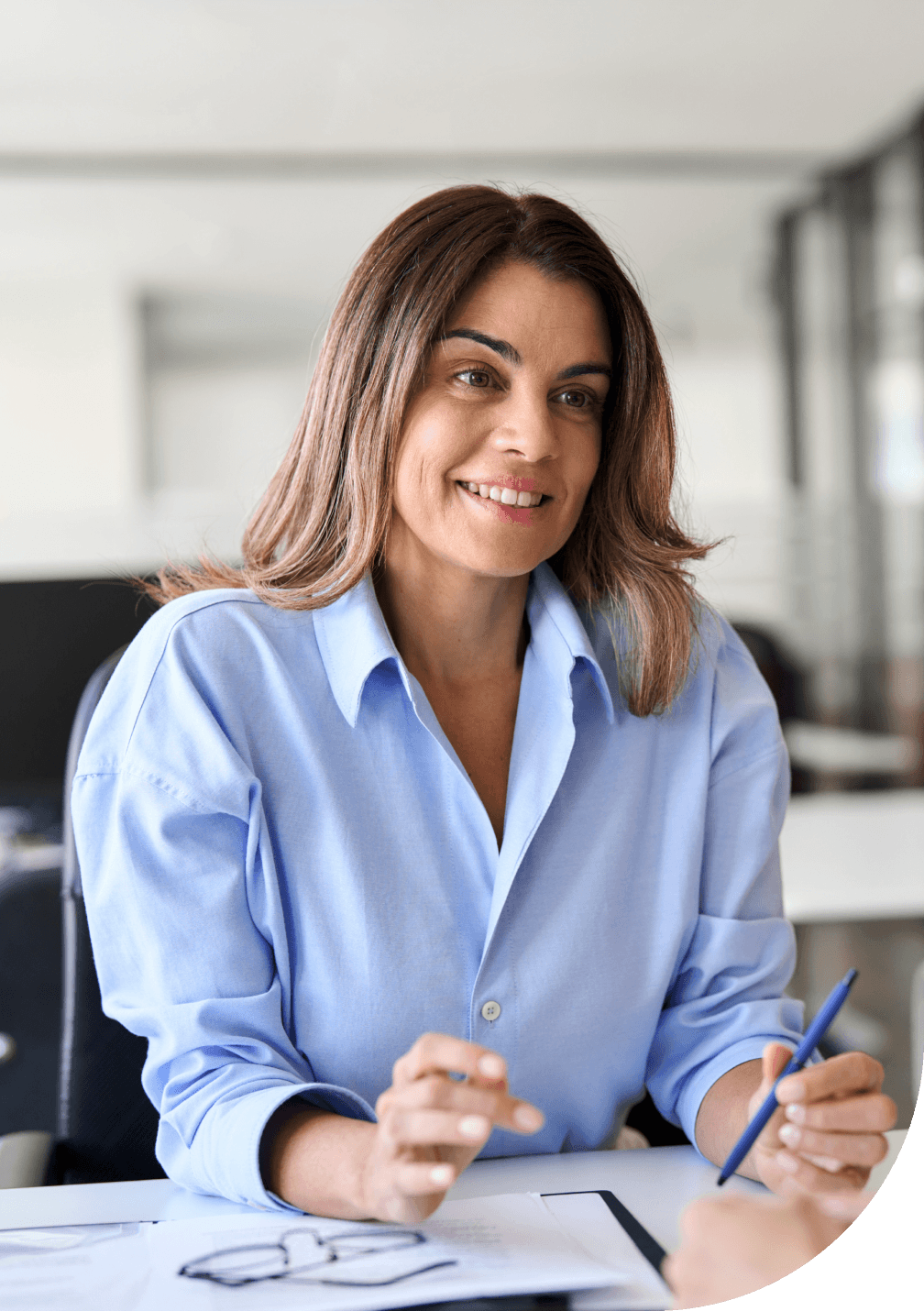 Une femme assise à un bureau.