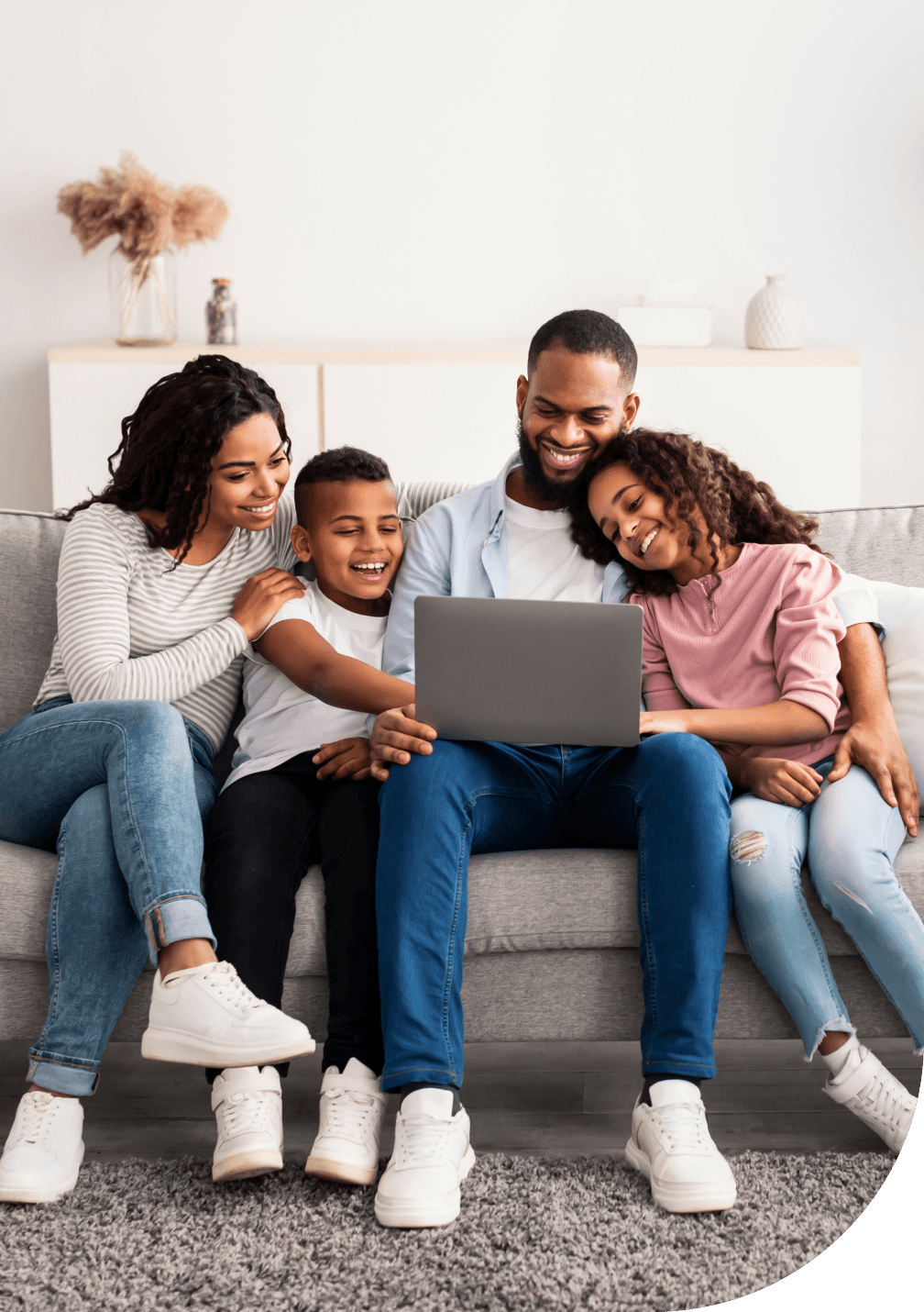 Happy family on a computer getting health advice online with TELUS Health after buying with Sonnet