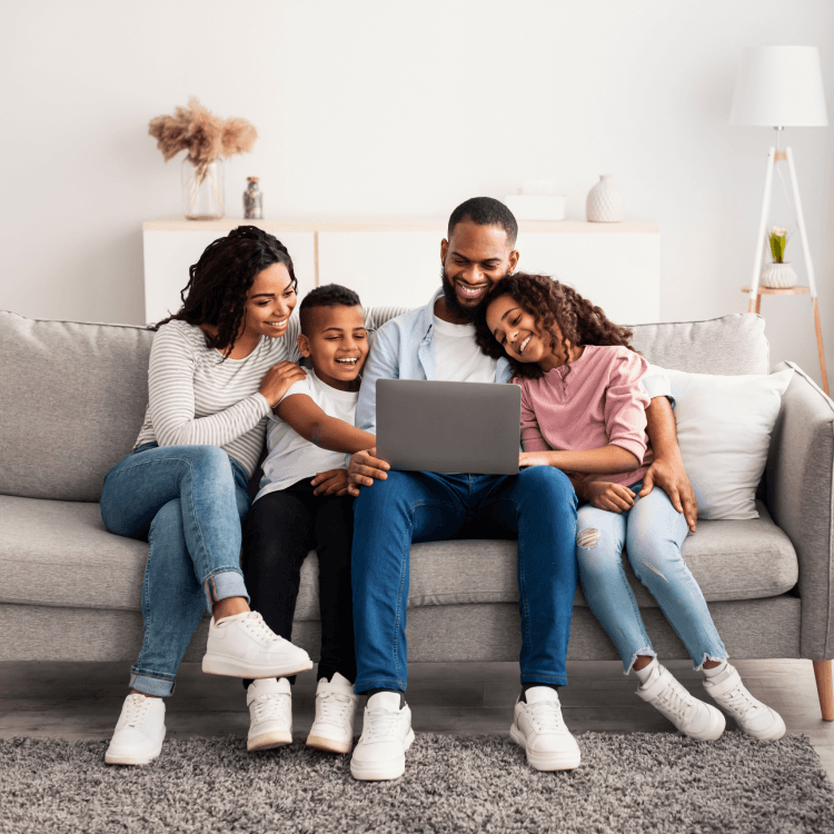 Happy family on a computer getting health advice online with TELUS Health after buying with Sonnet